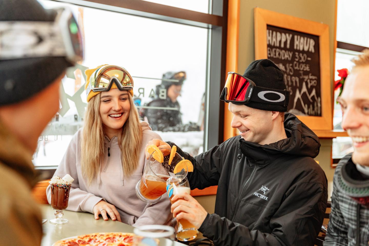 Friends sharing drinks and snacks at a café table.