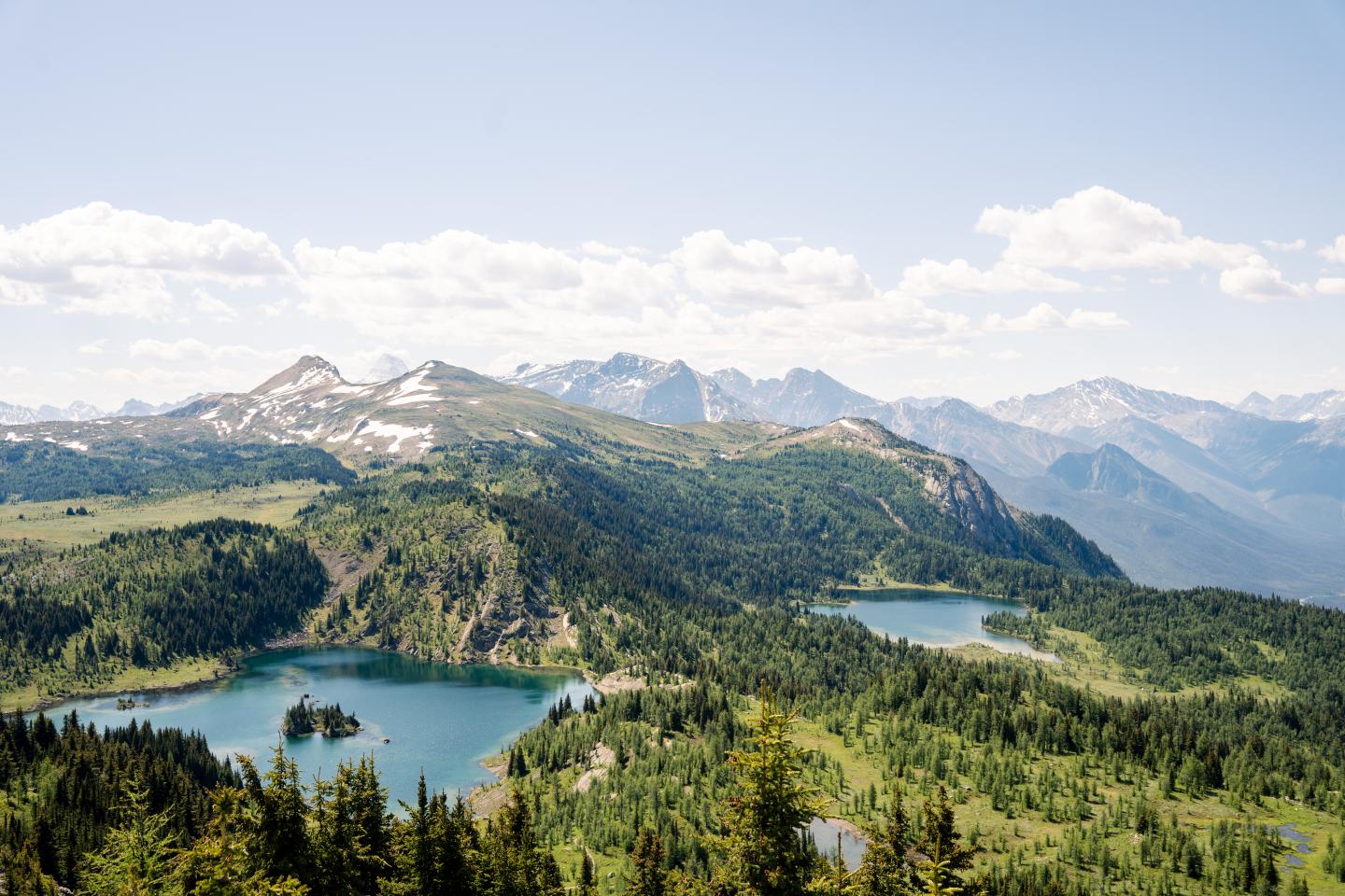 Mountain landscape with two lakes and scattered clouds.