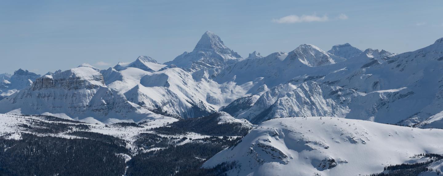 Snow-covered mountain range under a clear blue sky