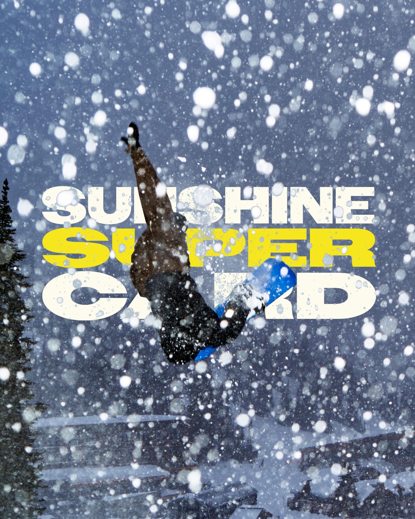 Snowboarder jumping before bold “Sunshine Slopes” text in falling snow.